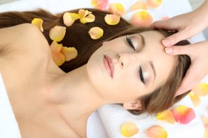 photo of woman receiving facial reflexology treatment