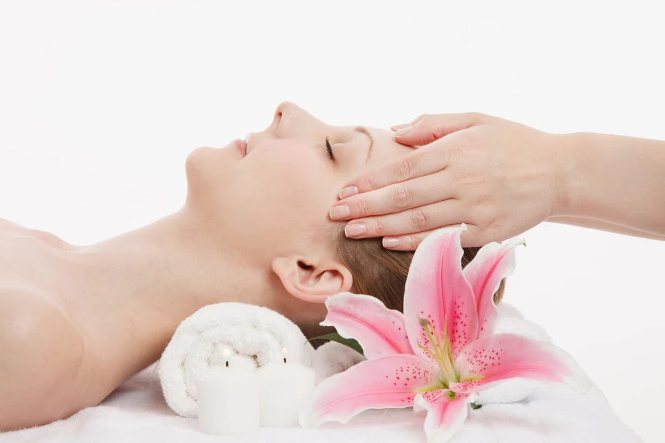 photo of woman receiving facial reflexology treatment