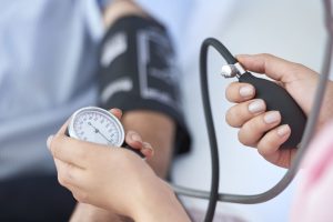 photo of person having their blood pressure tested for health screening