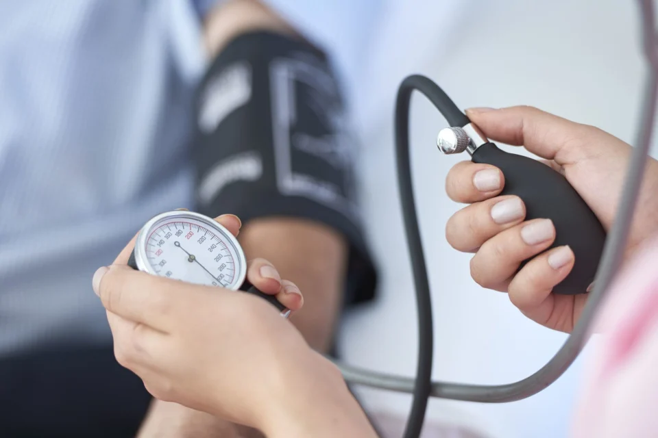 photo of person having their blood pressure tested for health screening