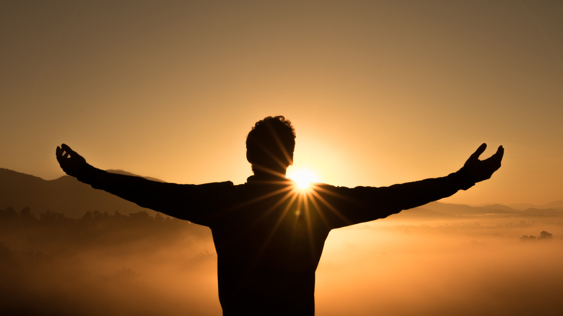 photo of man with arms outstretched